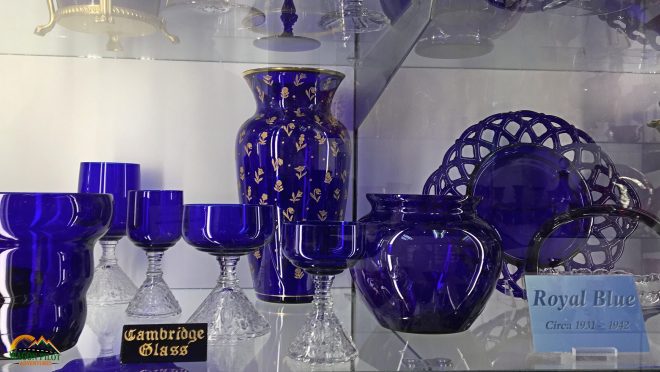 Collection of Royal Blue Cambridge Glassware Displayed on a Shelf