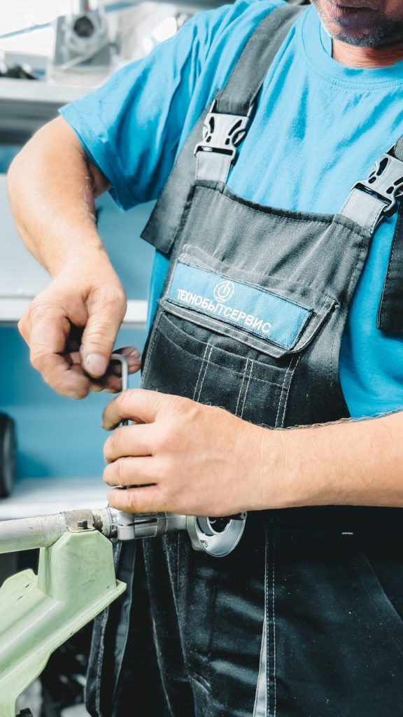 Plumber Fixing Pipe Joint with Wrench in Workshop Setting