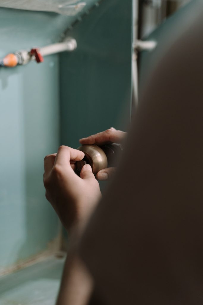 Plumber Adjusting Pipe Connection for Emergency Plumbing Services Near Me